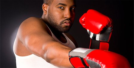 defensive posture - A boxer punches at you in red gloves Photographie de stock - Aubaine LD & Abonnement, Code: 400-07208635