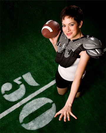 shoulder pad female - A female football player smiles as she throws a forward pass Stock Photo - Budget Royalty-Free & Subscription, Code: 400-07208646