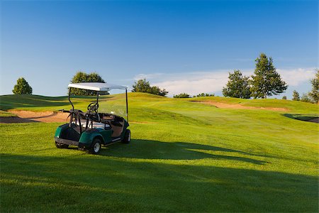 simsearch:400-07218310,k - Great view at the beautiful golf course with the green golf cart. Fotografie stock - Microstock e Abbonamento, Codice: 400-07209016