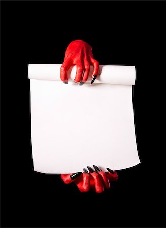 simsearch:400-07210691,k - Red devil hands holding paper scroll, deal with devil concept, isolated on black background Stock Photo - Budget Royalty-Free & Subscription, Code: 400-07209171