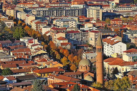 Urban buildings with red roofs and church lit by last rays of setting sun at evening in Alba, Italy (view from above). Stock Photo - Budget Royalty-Free & Subscription, Code: 400-07209207