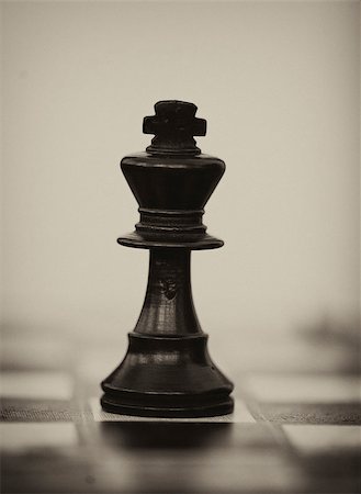Black wooden chess king on chess board Stock Photo - Budget Royalty-Free & Subscription, Code: 400-07209576