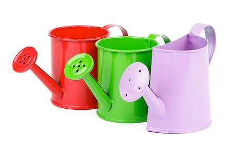 simsearch:6107-06117458,k - Purple, Green and Red Little Watering-Can In a Row isolated on white background Stock Photo - Budget Royalty-Free & Subscription, Code: 400-07209805