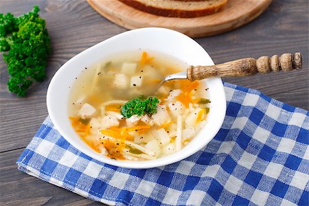 simsearch:400-04514565,k - Bowl of chicken soup with vegetables and noodles on a blue napkin Foto de stock - Super Valor sin royalties y Suscripción, Código: 400-07209813