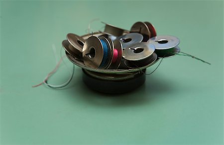 Spools for sewing machine. Wire coils piled in an old speaker magnet Stock Photo - Budget Royalty-Free & Subscription, Code: 400-07209957