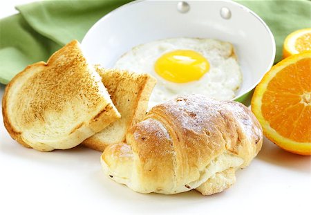 simsearch:400-04414187,k - Continental breakfast - croissant, fried egg, toast and oranges Photographie de stock - Aubaine LD & Abonnement, Code: 400-07214048