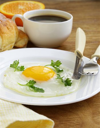 simsearch:400-04414187,k - Continental breakfast - croissant, fried egg, toast and oranges Photographie de stock - Aubaine LD & Abonnement, Code: 400-07214050
