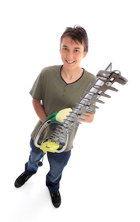 simsearch:400-07052460,k - Smiling male teenager holding an electric hedge trimmer.  White background, Photographie de stock - Aubaine LD & Abonnement, Code: 400-07214147