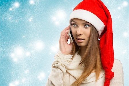 santa christmas hat women - christmas portrait of sensual  young girl with winter style, long smooth hair and red santa claus hat talking on the smartphone. Stock Photo - Budget Royalty-Free & Subscription, Code: 400-07214631