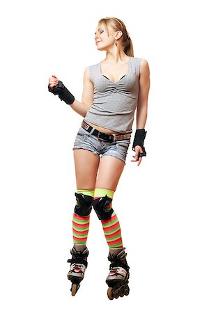 Playful beautiful young woman on roller skates Photographie de stock - Aubaine LD & Abonnement, Code: 400-07214682