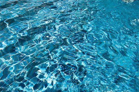 Background of deep blue swimming pool water sparkling in sunlight Foto de stock - Super Valor sin royalties y Suscripción, Código: 400-07214987