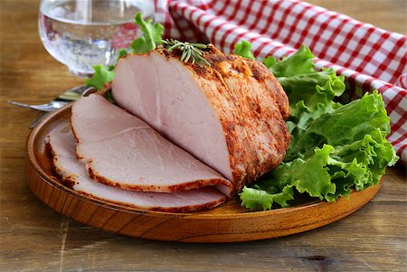 roasted ham - roast pork with paprika and rosemary served on a wooden plate Stock Photo - Budget Royalty-Free & Subscription, Code: 400-07215295