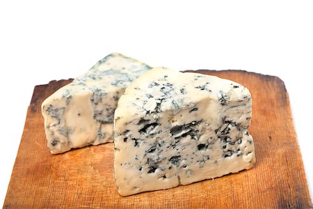 simsearch:400-05682309,k - Dorblu cheeses on old wooden kitchen board. On white background Stock Photo - Budget Royalty-Free & Subscription, Code: 400-07215515