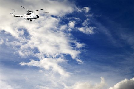 rescuer - Helicopter in sunny blue sky with clouds Stock Photo - Budget Royalty-Free & Subscription, Code: 400-07216420