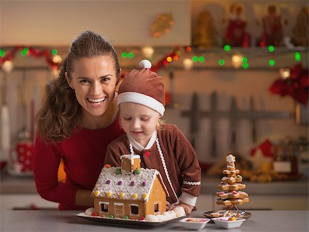 decor home new year - Smiling mother and baby decorating christmas cookie house in kitchen Stock Photo - Budget Royalty-Free & Subscription, Code: 400-07217205