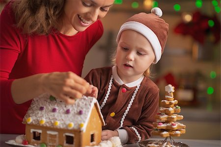 decor home new year - Happy mother and baby decorating christmas cookie house in kitchen Stock Photo - Budget Royalty-Free & Subscription, Code: 400-07217206
