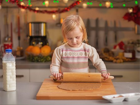 decor home new year - Baby rolling pin dough in christmas decorated kitchen Stock Photo - Budget Royalty-Free & Subscription, Code: 400-07217234