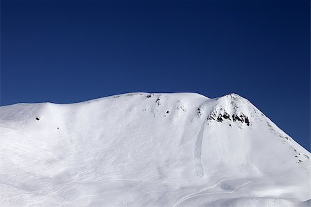 simsearch:400-08780271,k - Off-piste slope with trace of skis, snowboarding and avalanche. Caucasus Mountains, Georgia, ski resort Gudauri. Photographie de stock - Aubaine LD & Abonnement, Code: 400-07217916