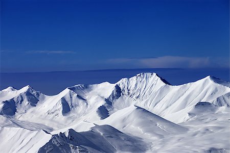 simsearch:400-07222348,k - Snowy mountains at sunny day and multicolor blue sky. Caucasus Mountains, Georgia, ski resort Gudauri. Fotografie stock - Microstock e Abbonamento, Codice: 400-07217917