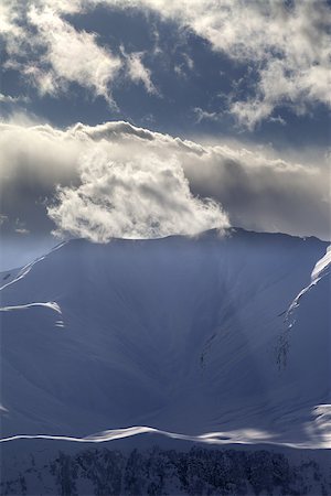 simsearch:400-07211845,k - Evening mountains with sunlit clouds. Caucasus Mountains, Georgia, view from ski resort Gudauri. Stockbilder - Microstock & Abonnement, Bildnummer: 400-07217920