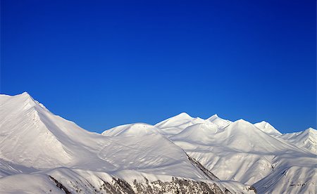 simsearch:400-04308471,k - Snowy mountains and blue clear sky. Caucasus Mountains, Georgia, ski resort Gudauri. Stock Photo - Budget Royalty-Free & Subscription, Code: 400-07217921