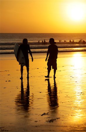 simsearch:400-07212763,k - Silhouette of surfers in golden sunset light. Bali Photographie de stock - Aubaine LD & Abonnement, Code: 400-07217948