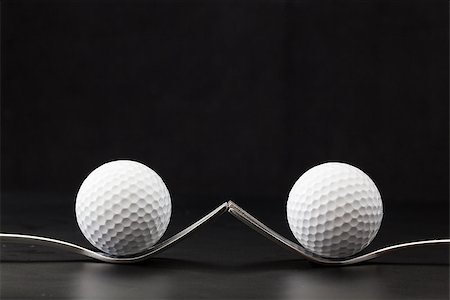 simsearch:400-07218299,k - Different golf balls on the black table Stock Photo - Budget Royalty-Free & Subscription, Code: 400-07218302