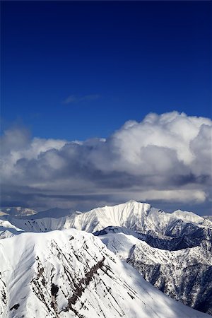 simsearch:400-07217910,k - Winter snowy sunlit mountains and sky with clouds. Caucasus Mountains, Georgia, view from ski resort Gudauri. Stock Photo - Budget Royalty-Free & Subscription, Code: 400-07219039