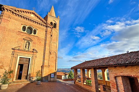 Red brick catholic church on small cobbled square under beautiful blue sky with white clouds in town of Monticello D'Alba in Piedmont, Italy. Stock Photo - Budget Royalty-Free & Subscription, Code: 400-07210156