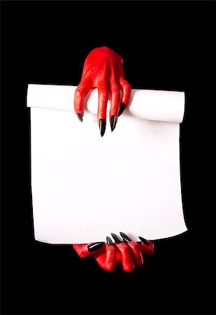 simsearch:400-07209176,k - Red devil hands holding paper scroll for deal with devil concept, isolated on black background Stockbilder - Microstock & Abonnement, Bildnummer: 400-07210669