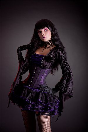 simsearch:400-07209176,k - Romantic gothic girl in purple and black gothic Halloween outfit, studio shot on black background Stockbilder - Microstock & Abonnement, Bildnummer: 400-07210679