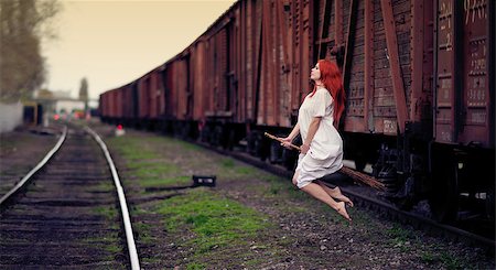 simsearch:400-07776243,k - Redhead witch flying on the broom on train station Fotografie stock - Microstock e Abbonamento, Codice: 400-07210696