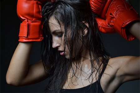 sweaty fighter - beautiful woman with the red boxing gloves, black background Stock Photo - Budget Royalty-Free & Subscription, Code: 400-07211506