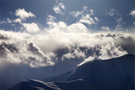 simsearch:400-07211845,k - Evening mountain in haze and sunlight clouds. View from ski resort Gudauri. Caucasus Mountains, Georgia. Stockbilder - Microstock & Abonnement, Bildnummer: 400-07211845