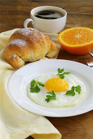 simsearch:400-04414187,k - Continental breakfast - croissant, fried egg, toast and oranges Photographie de stock - Aubaine LD & Abonnement, Code: 400-07212036
