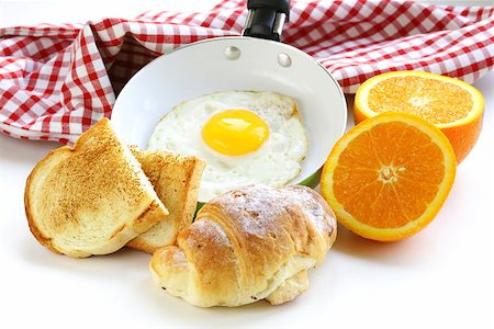 simsearch:400-04414187,k - Continental breakfast - croissant, fried egg, toast and oranges Photographie de stock - Aubaine LD & Abonnement, Code: 400-07212390