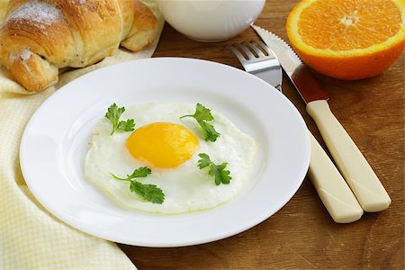 simsearch:400-04414187,k - Continental breakfast - croissant, fried egg, toast and oranges Photographie de stock - Aubaine LD & Abonnement, Code: 400-07212392