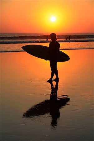 simsearch:400-07212763,k - Silhouette of surfer with a board on a sunset Photographie de stock - Aubaine LD & Abonnement, Code: 400-07212725