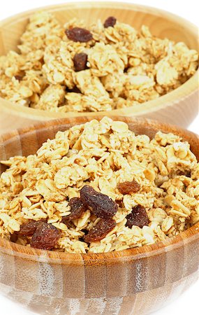 simsearch:400-08152810,k - Breakfast Cereal Flakes with Slices of Nuts and Raisins closeup in Two Wooden Bowls Photographie de stock - Aubaine LD & Abonnement, Code: 400-07212840