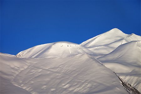 simsearch:400-04308471,k - Off-piste slope and blue clear sky in nice winter morning. Ski resort Gudauri. Caucasus Mountains, Georgia. Stock Photo - Budget Royalty-Free & Subscription, Code: 400-07213917