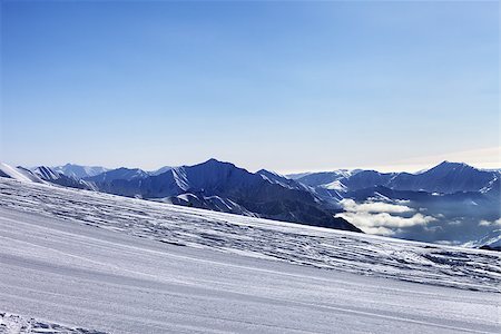 simsearch:400-08780271,k - Ski slope and snowy mountain in haze. Georgia, ski resort Gudauri. Caucasus Mountains. Photographie de stock - Aubaine LD & Abonnement, Code: 400-07213913