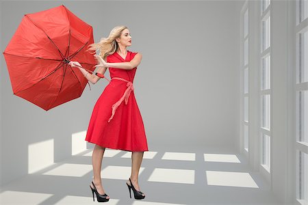 Composite image of beautiful woman posing with a broken umbrella with her leg raised Stock Photo - Budget Royalty-Free & Subscription, Code: 400-07224500