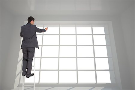 simsearch:400-08020381,k - Composite image of businessman standing on ladder writing Fotografie stock - Microstock e Abbonamento, Codice: 400-07224569