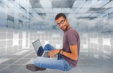 Composite image of man wearing glasses sitting on floor using laptop and looking at camera Stock Photo - Budget Royalty-Free & Subscription, Code: 400-07225148