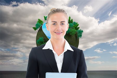 female business woman holding ball - Composite image of blonde businesswoman holding tablet Stock Photo - Budget Royalty-Free & Subscription, Code: 400-07225243
