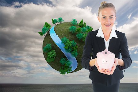 female business woman holding ball - Composite image of blonde businesswoman holding pink piggy bank Stock Photo - Budget Royalty-Free & Subscription, Code: 400-07225349