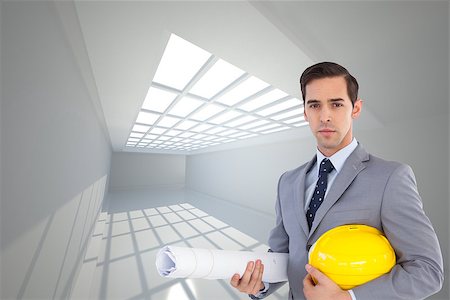 Composite image of serious architect holding plans and hard hat Stock Photo - Budget Royalty-Free & Subscription, Code: 400-07225542