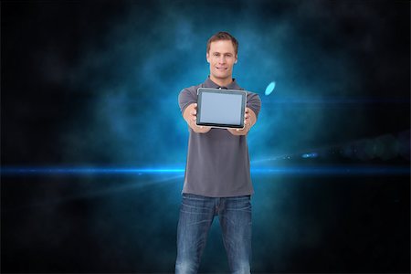 simsearch:400-07664794,k - Composite image of young man showing screen of his tablet computer Stock Photo - Budget Royalty-Free & Subscription, Code: 400-07225703