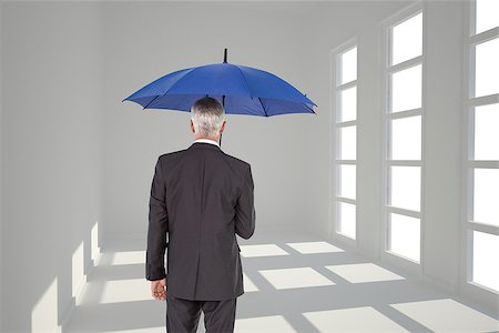 Composite image of mature businessman holding umbrella Stock Photo - Budget Royalty-Free & Subscription, Code: 400-07225722