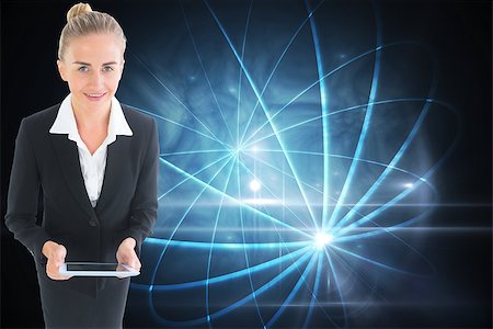 female business woman holding ball - Composite image of blonde businesswoman holding new tablet Stock Photo - Budget Royalty-Free & Subscription, Code: 400-07225806